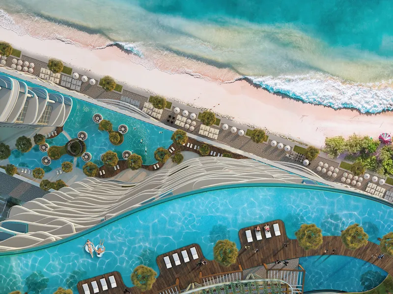 Overhead view of the podium pools, sunbeds and the beach at DAMAC Bay by Cavalli