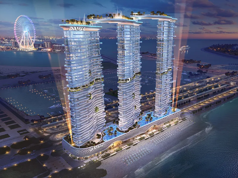 Aerial night view of the three DAMAC Bay by Cavalli towers on the Dubai Harbour seafront