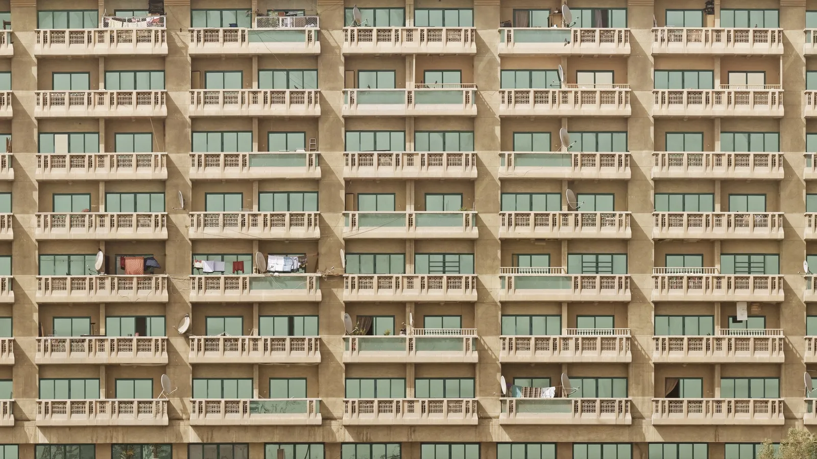 The balconies of an older apartment building beside Dubai Creek