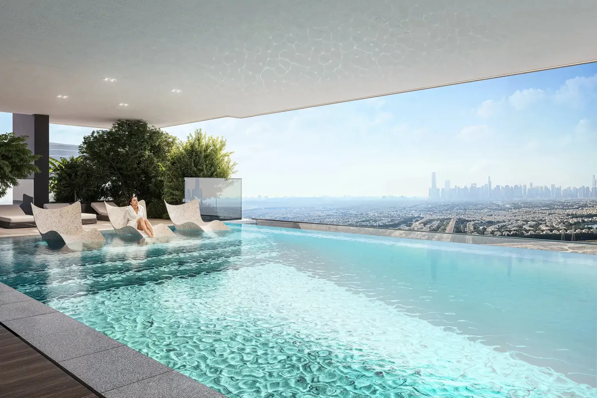 Infinity pool at ELAR1S RISE with in-water loungers and a view over JVT to the Dubai Marina skyline