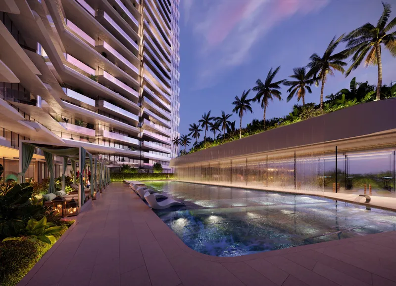 Render of the podium swimming pool at Eleve at dusk, with the tower's curved balconies on the left