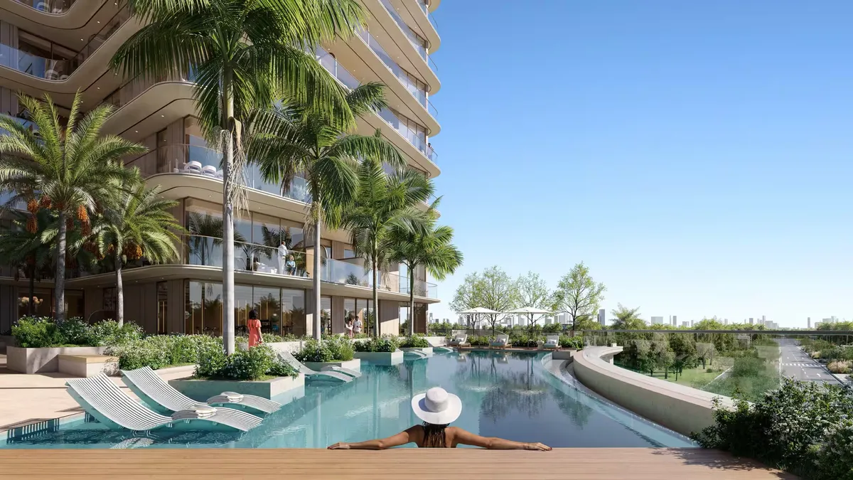 Pool with sun loungers and palm trees at Enre Residence