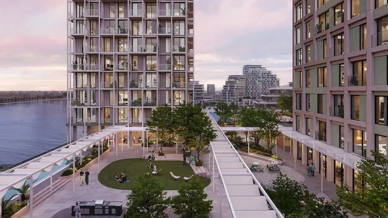 Render of the landscaped courtyard between the buildings at Enta Mina at dusk