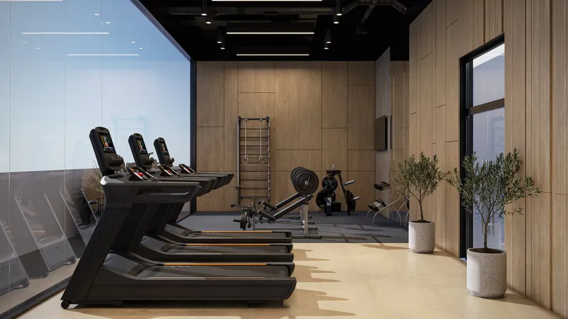 Rooftop gym at Estrella by Nexus with treadmills facing a glass wall