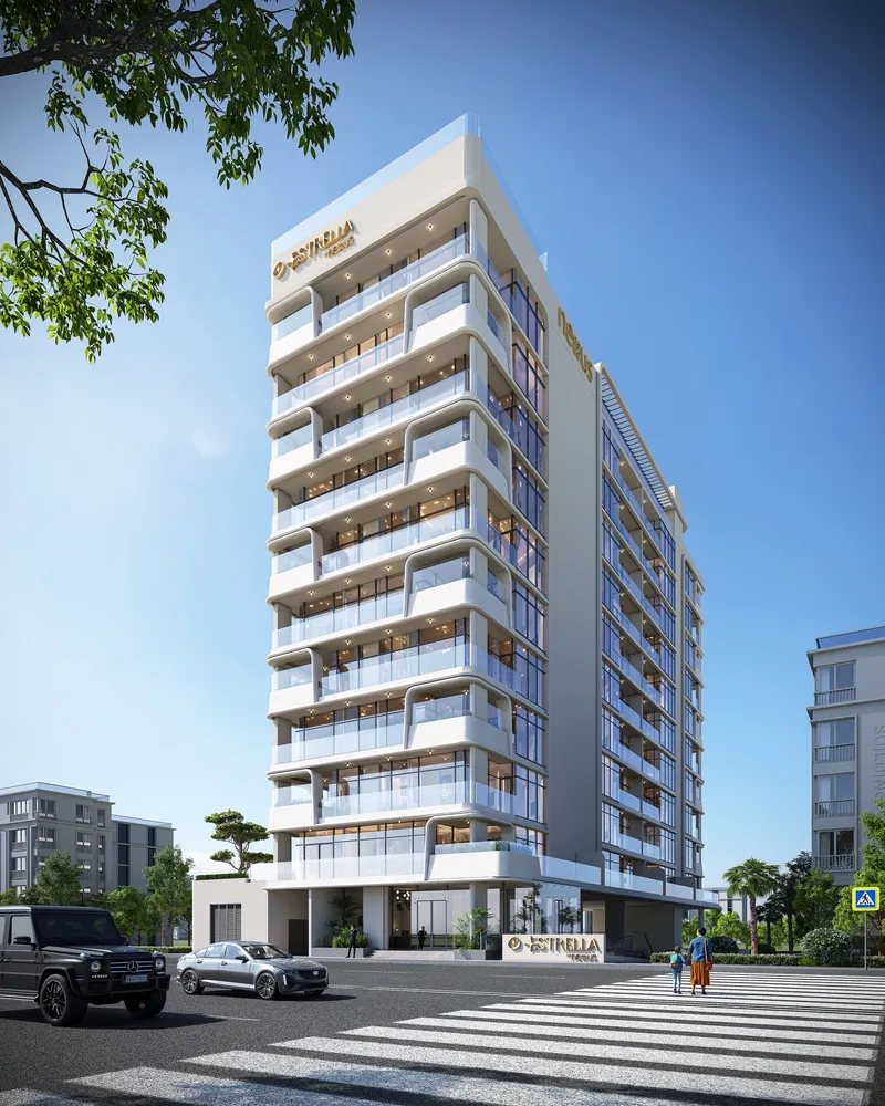 Corner view of Estrella by Nexus from the street, showing curved white balconies on every floor