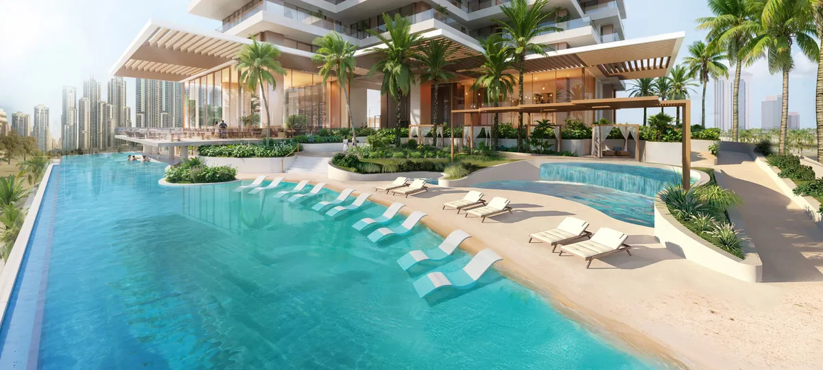 Podium infinity pool with sun loungers and palm trees at Fairmont Residences Solara Tower