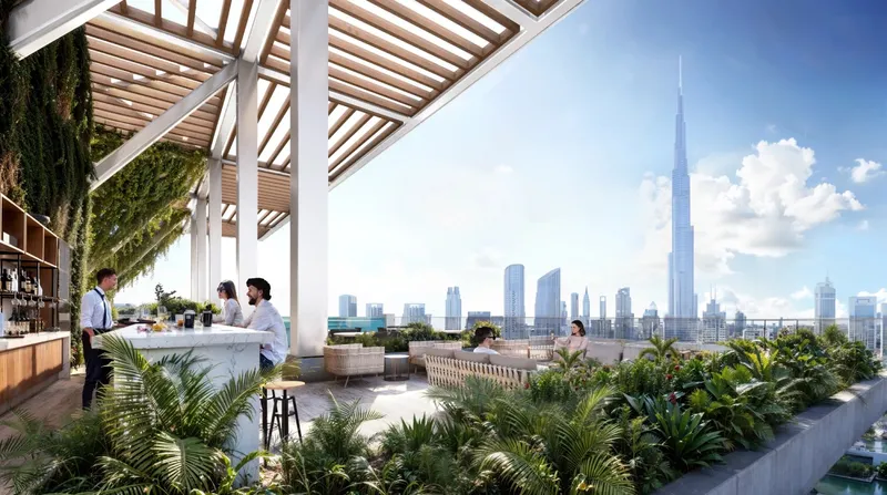 Rooftop pool bar under a timber pergola with a view of Burj Khalifa