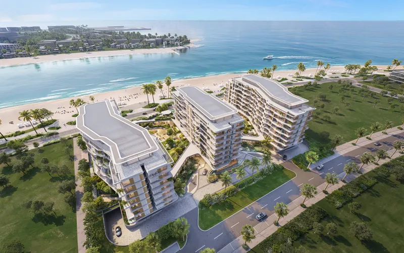 Aerial render of Flora Isle's three curved eight-storey buildings on the beachfront of Dubai Islands