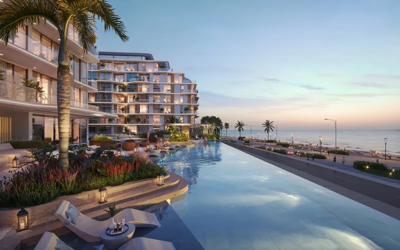 Evening render of the Flora Isle infinity pool with loungers, running alongside the beachfront promenade