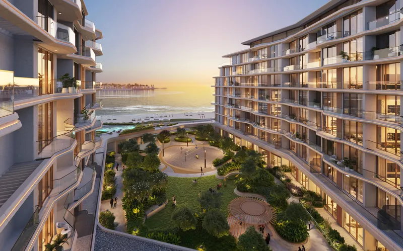 Dusk render of the landscaped podium garden between the Flora Isle buildings, with the sea beyond