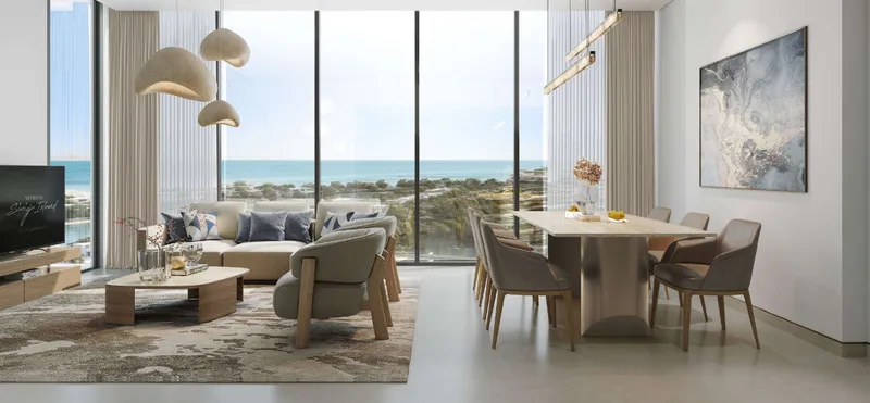 Living and dining room of a Beach Residences apartment on Sobha Siniya Island with full-height windows to the sea
