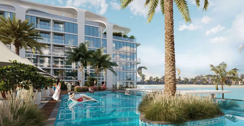 Swimming pool and sun deck beside a building at Florine Beach Residences, with the lagoon beyond
