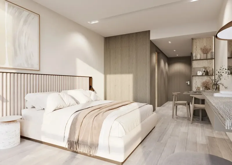Bedroom in a Gharbi II apartment with timber wall panelling and a study desk