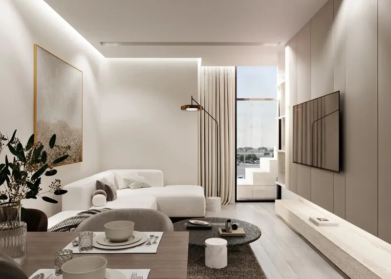Living and dining area in a Gharbi II apartment in pale neutral tones