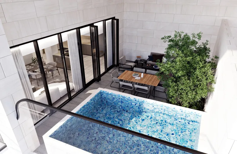 Private terrace with a tiled plunge pool and dining table at a Gharbi II home, seen from above