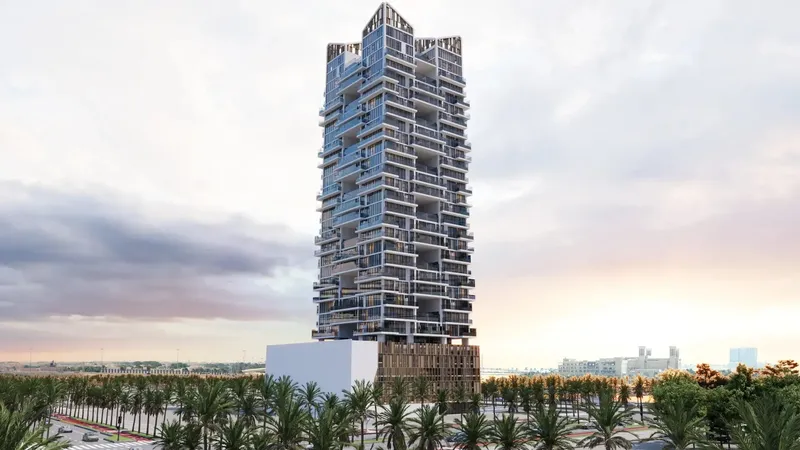 Gharbi II Residences tower at dusk above palm trees