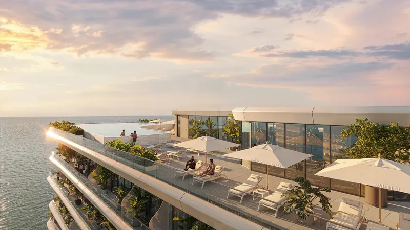 Render of the rooftop terrace with sunbeds and parasols at Gianfranco Ferré Residences at sunset