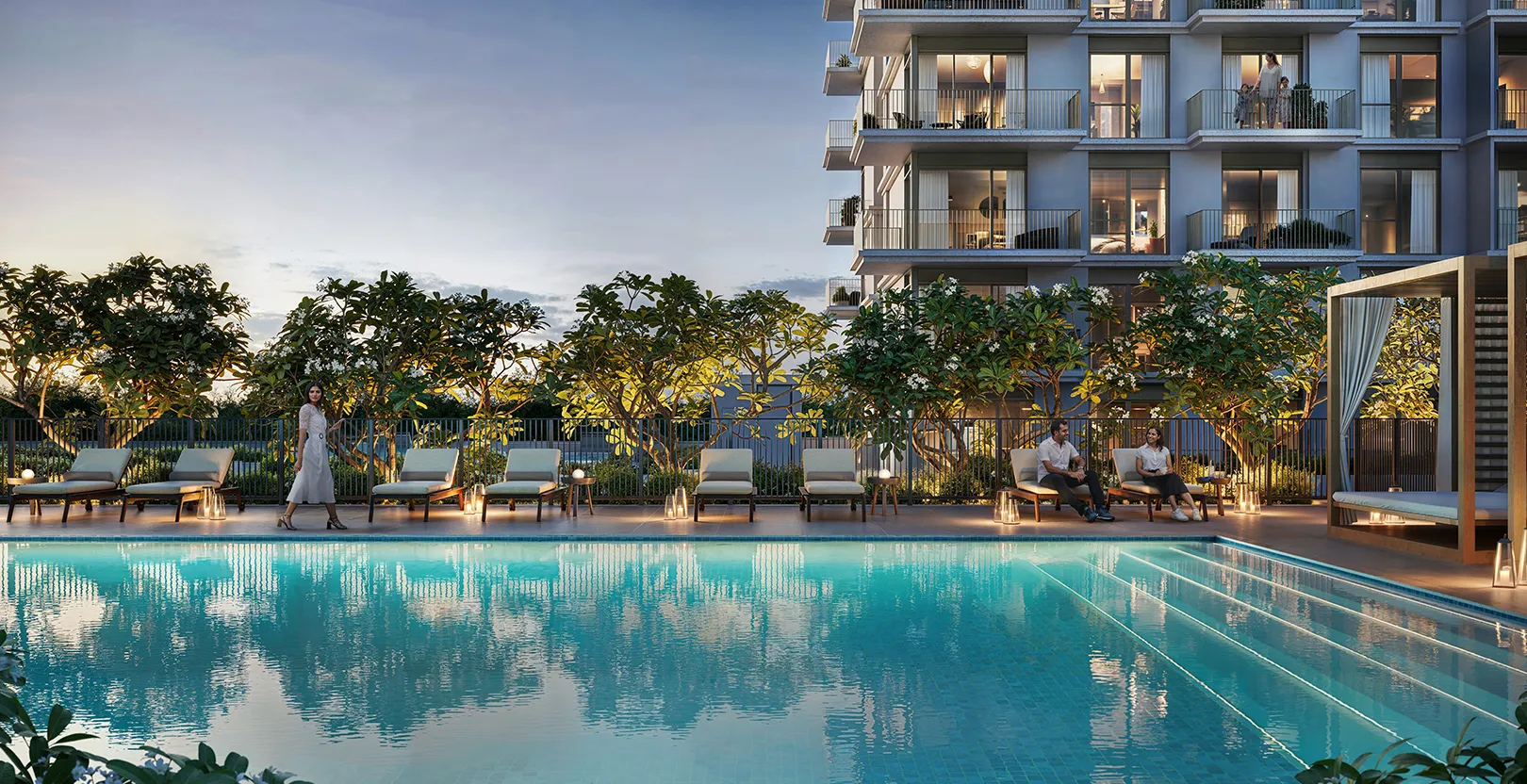 Render of the Golf Dale swimming pool at dusk with sun loungers, a cabana and the apartment building behind