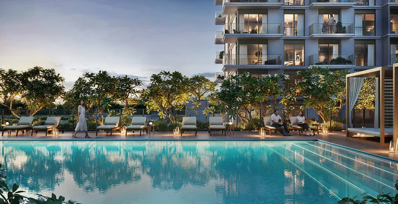 Render of the Golf Dale swimming pool at dusk with sun loungers, a cabana and the apartment building behind