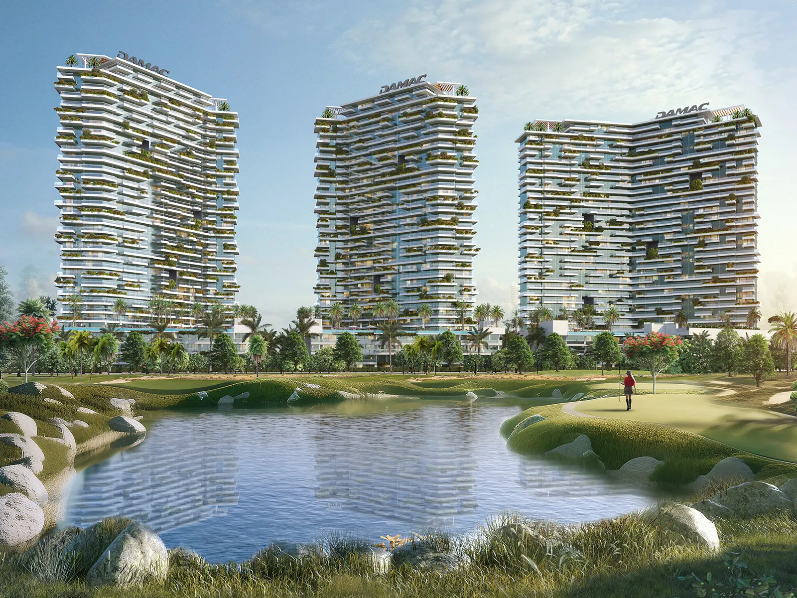 The three Golf Greens towers seen across a lake and fairway at DAMAC Hills