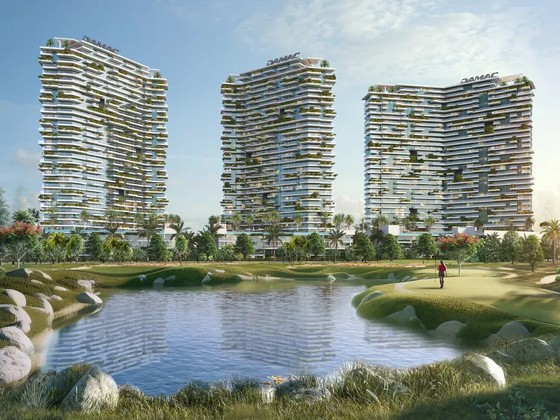 The three Golf Greens towers seen across a lake and fairway at DAMAC Hills