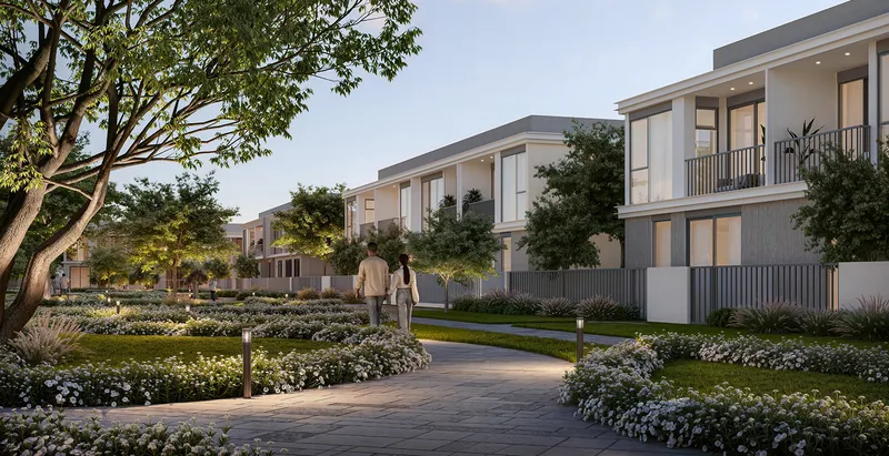 Render of a landscaped walkway between rows of Greenway 2 townhouses at dusk