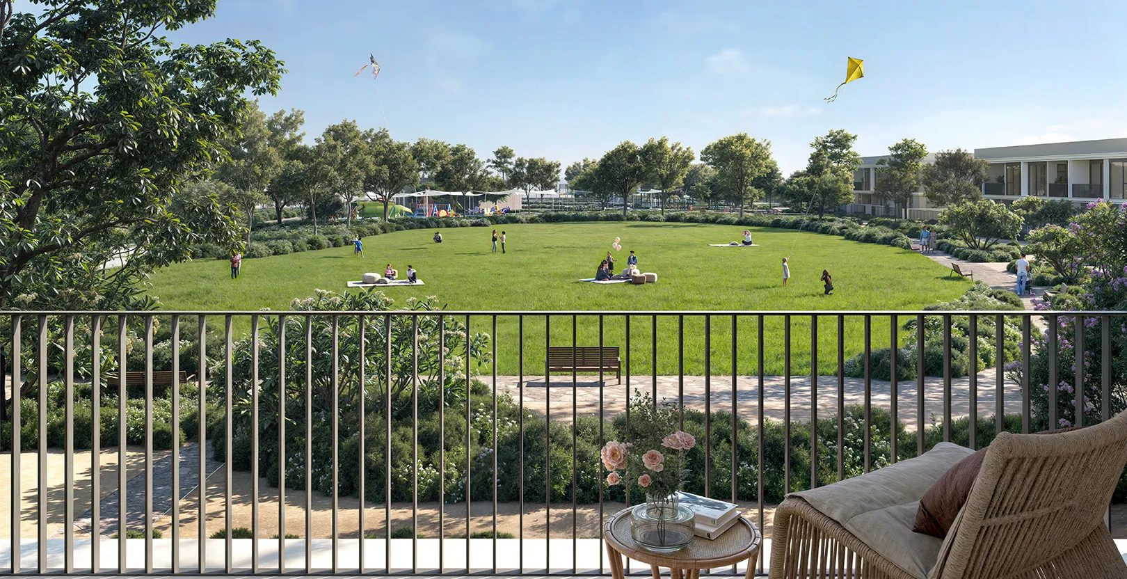 Render of the view from a Greenway 2 terrace over a community park lawn with families and kites