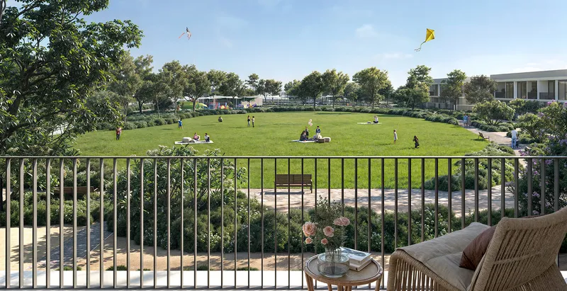 Render of the view from a Greenway 2 terrace over a community park lawn with families and kites