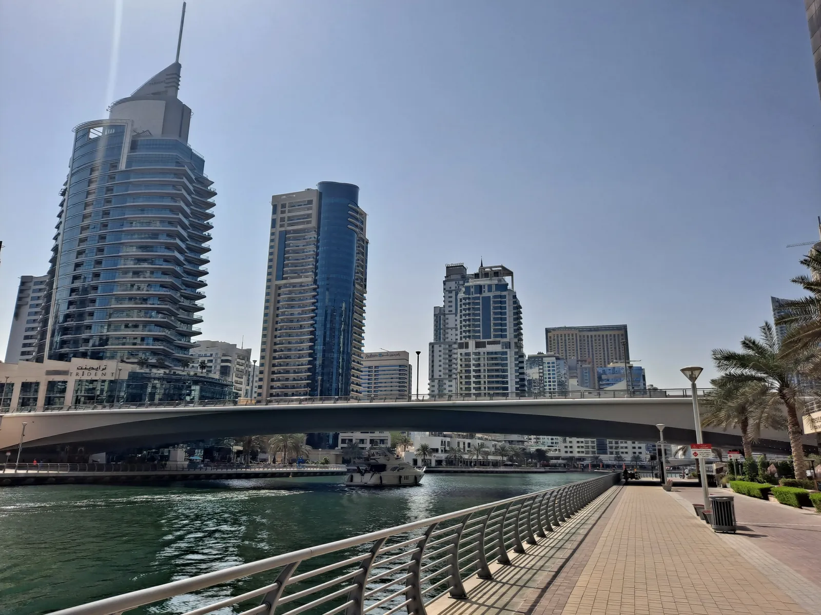 Residential towers and a footbridge along the waterfront promenade at Dubai Marina