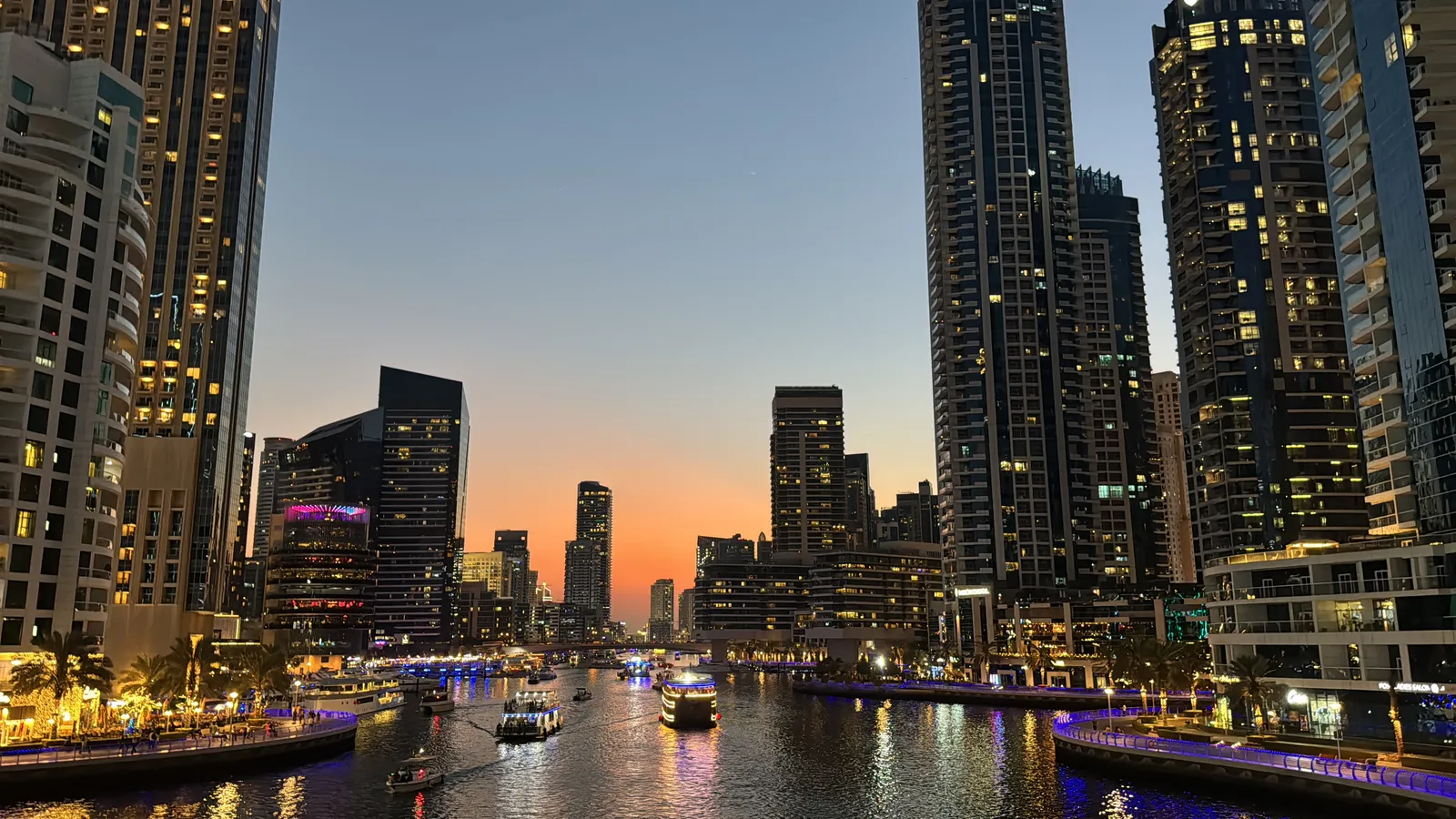 Dubai Marina at dusk, with residential towers lit along the water