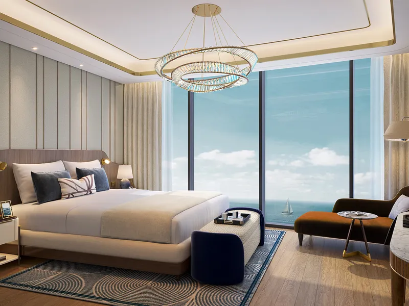 Bedroom at Harbour Lights with floor-to-ceiling windows facing the sea