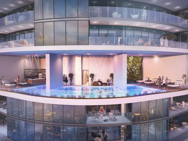 Pool deck with loungers and a bar set within the Harbour Lights tower