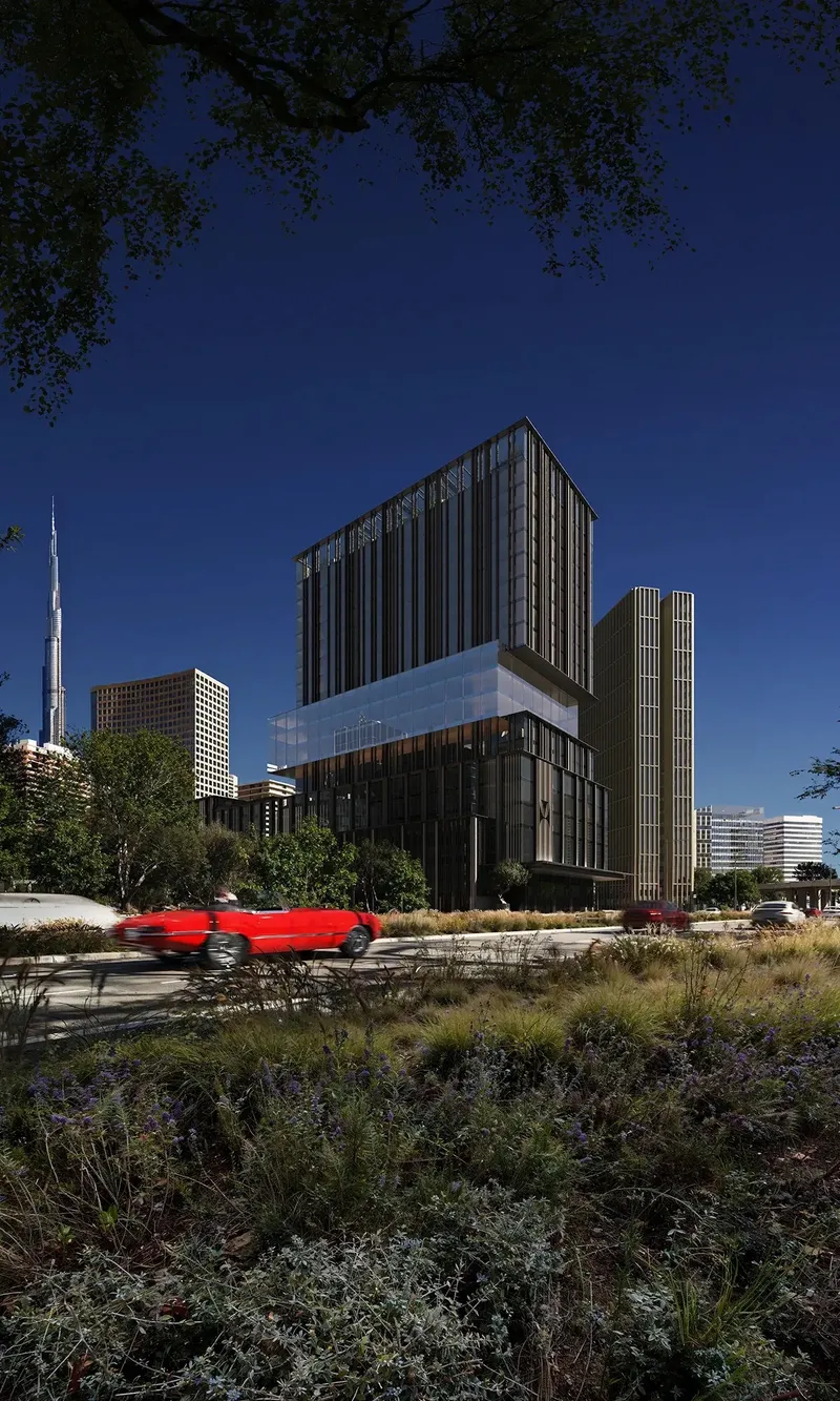 Street-level render of Haus of Tenet behind landscaped planting under a deep blue sky