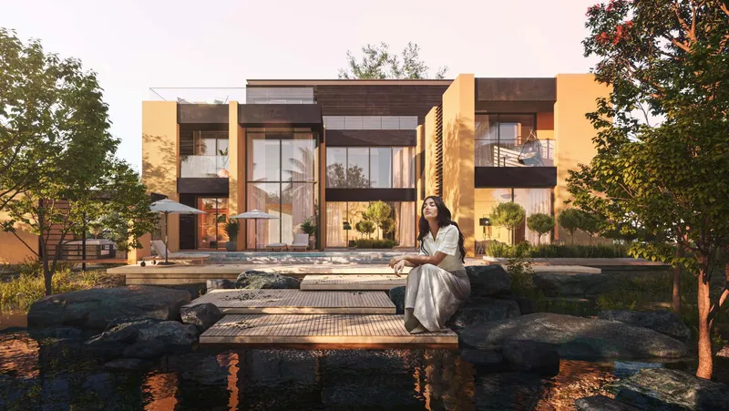 Render of a Haven by Aldar villa seen across the community stream at sunset