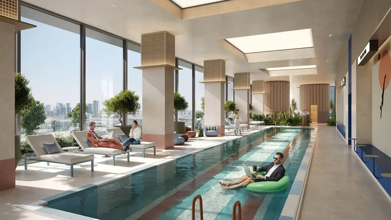Indoor lap pool with sun loungers and tall windows at HQ by Rove