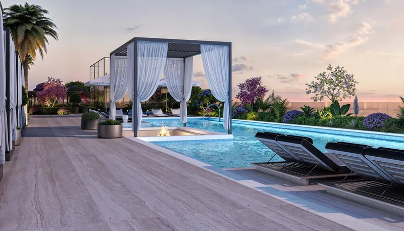Pool deck with a curtained cabana, fire feature and loungers at Interstellar Tower