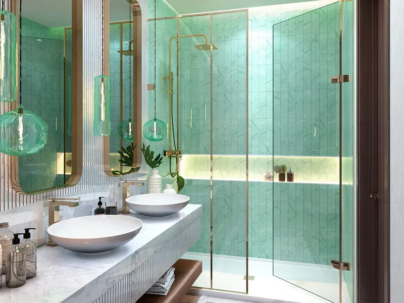 Bathroom in a Lagoon Views apartment with green tiling and a glass shower