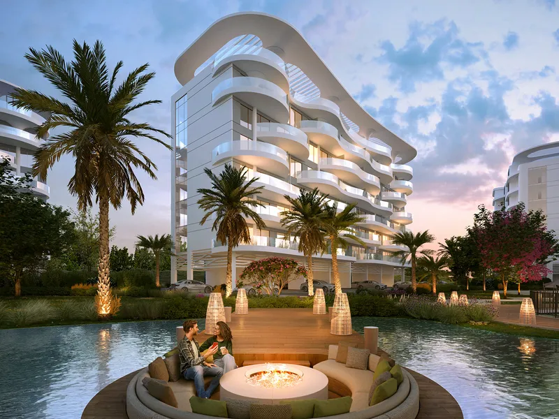 A Lagoon Views building at dusk with a fire pit lounge on the water in front