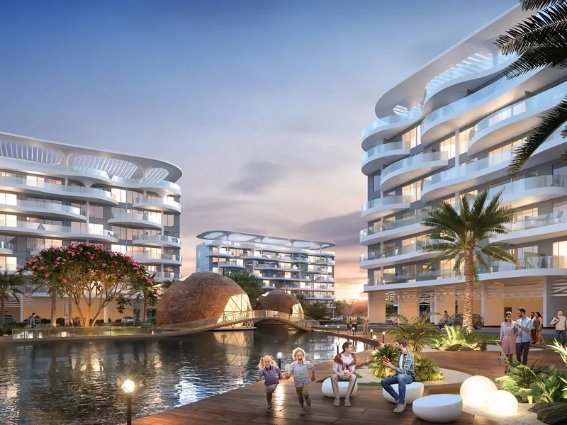 Lagoon Views buildings at dusk with waterside seating and thatched pavilions