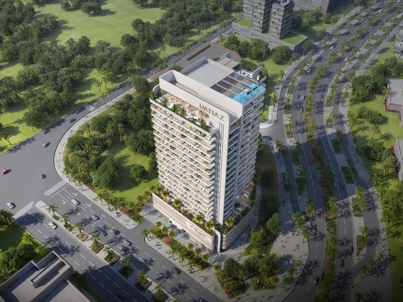 Aerial view of the white Le Blanc tower beside a landscaped park