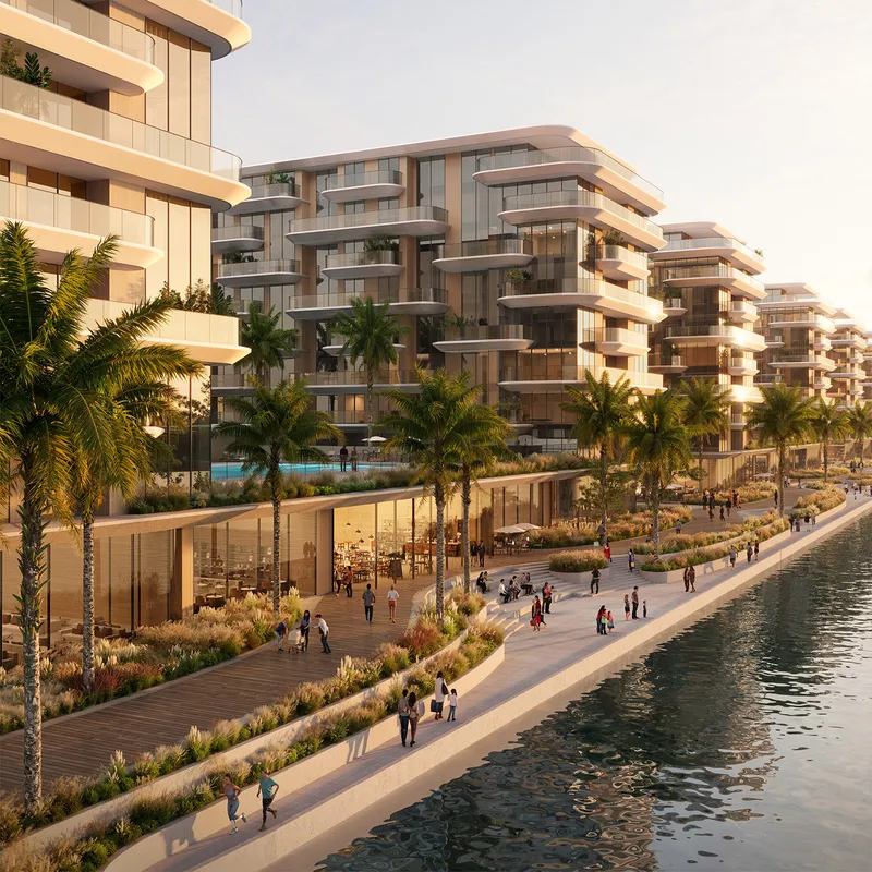 Terraced apartment buildings above a palm-lined promenade on Yas Canal
