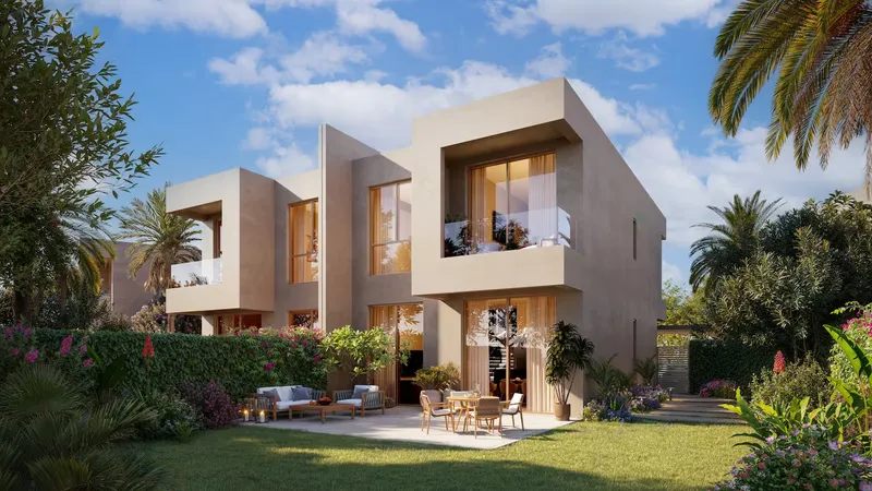 Garden side of a duplex home with an outdoor dining terrace and lawn