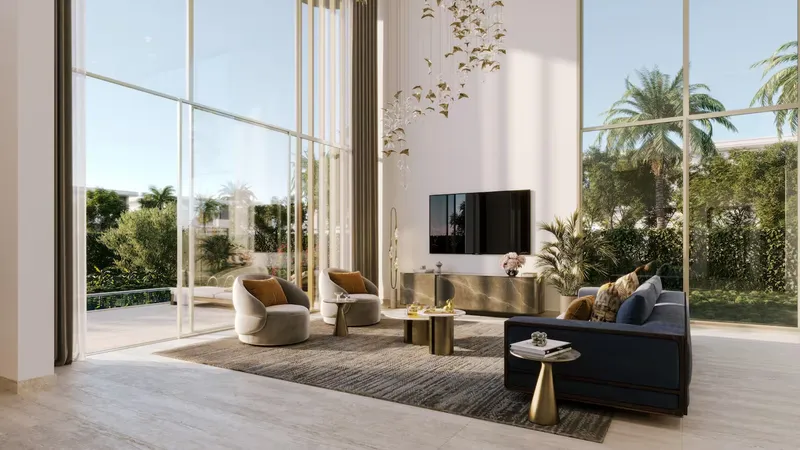 Double-height villa living room with floor-to-ceiling windows onto the garden