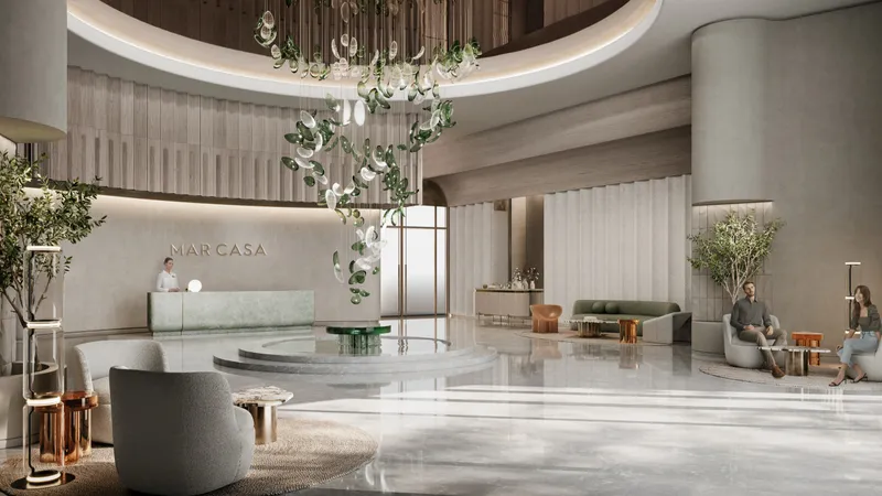 Render of the Mar Casa lobby with a hanging light installation and marble floors