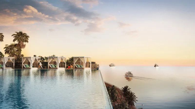 Render of the sand infinity pool with cabanas and palm trees at Mar Casa
