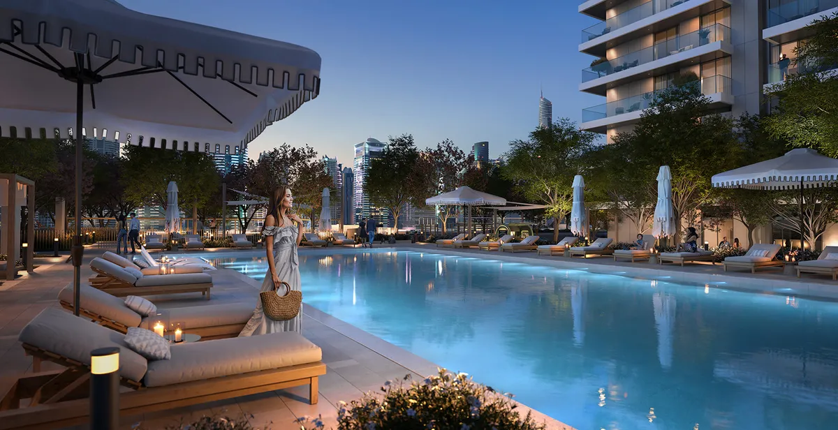 Render of the Marina Cove outdoor swimming pool at dusk with loungers and parasols