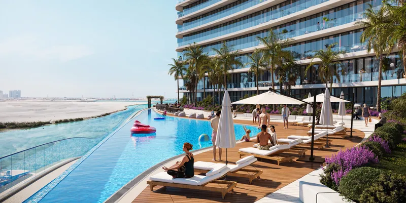 Infinity pool with sun loungers and parasols at Marlin II, facing the water (developer render)