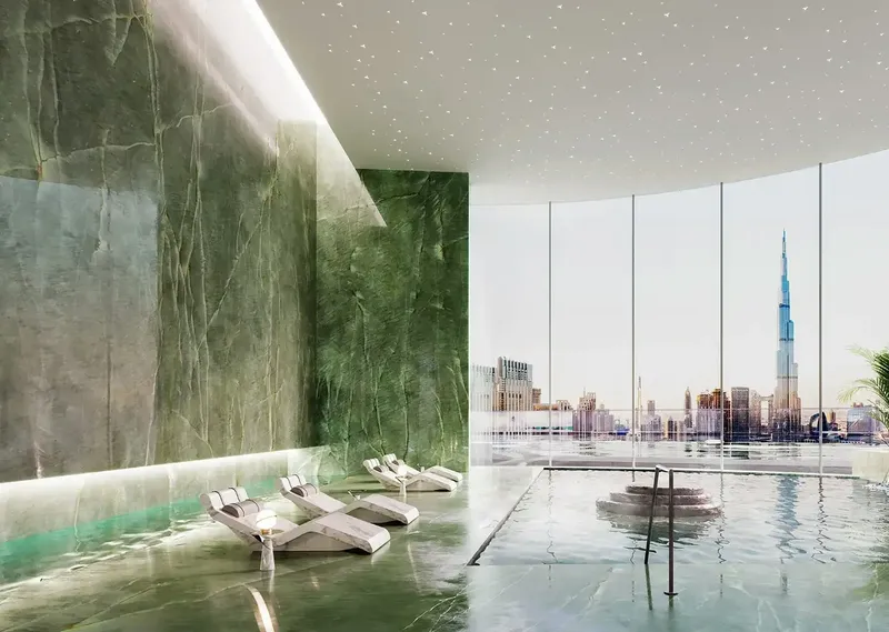 Render of the spa pool with green stone walls and loungers at Mercedes-Benz Places | Binghatti