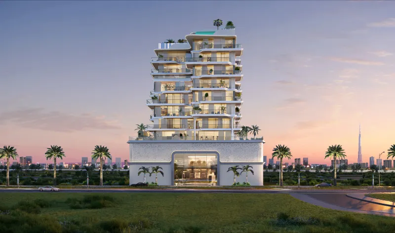 Meriden Beach Residences at dusk with its arched entrance and stepped white balconies