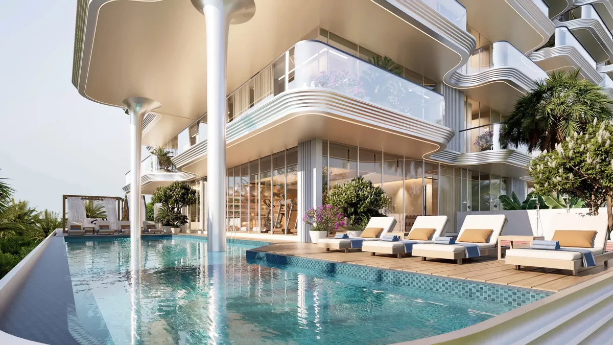 Swimming pool with sunbeds on the podium deck of Meriden Beach Residences